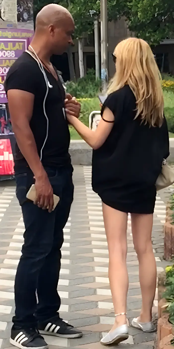 Deepak speaking with a woman outdoors